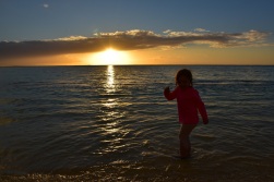 Our 3 and a half year old watching the sunset while playing in the gentle waves in Mauritius!